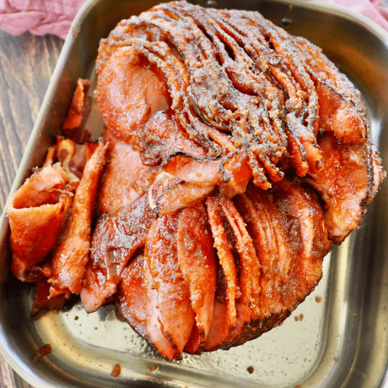 Copycat Honeybaked Ham spiral sliced ham with sugar crusted glaze in roasting pan.