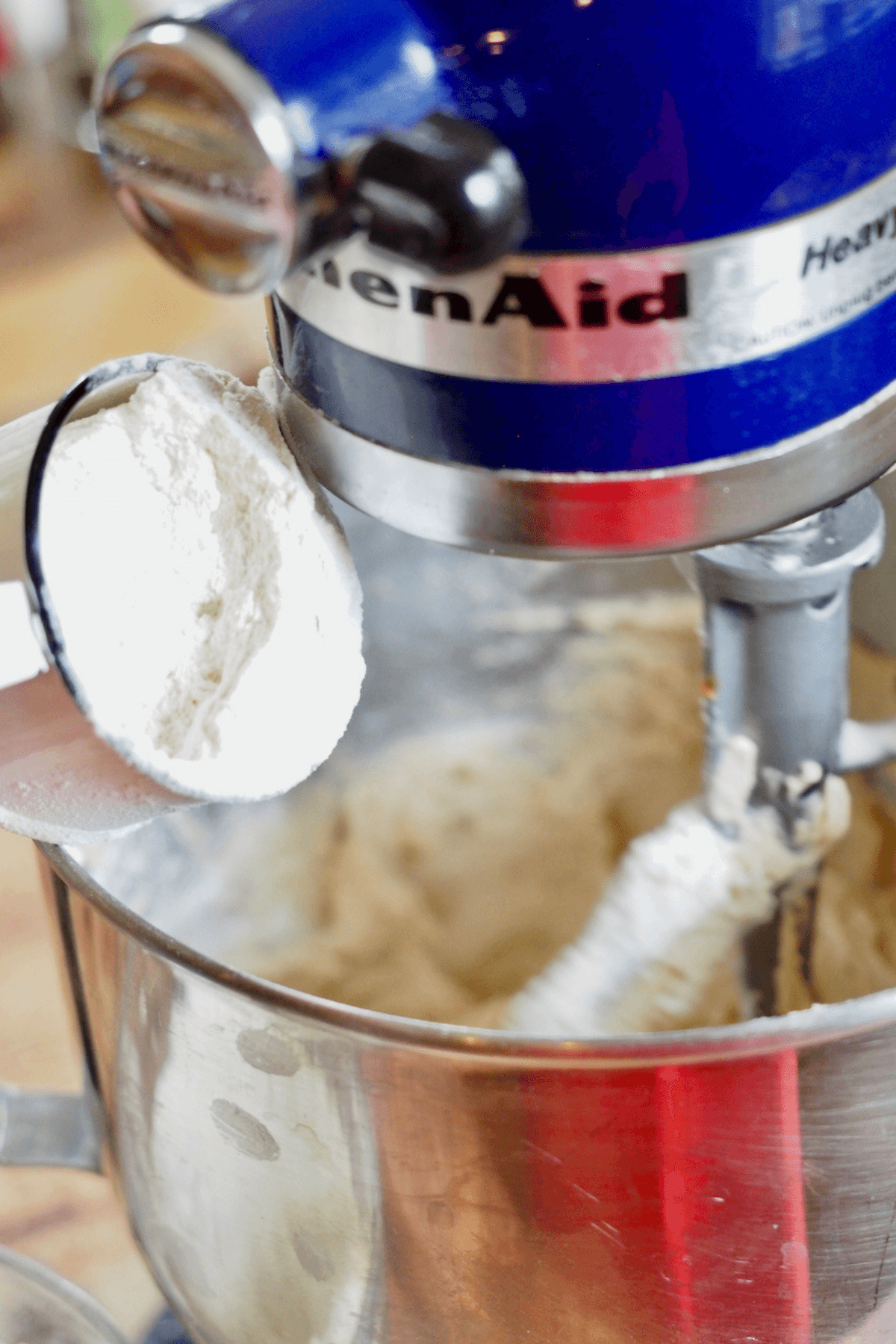 Slowly adding flour mixture into crumbl cookie batter.