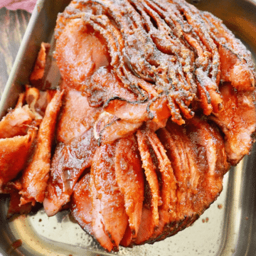 Top down shot of honeybaked spiral cut ham in roasting pan, perfectly juicy and sugar-crusted.