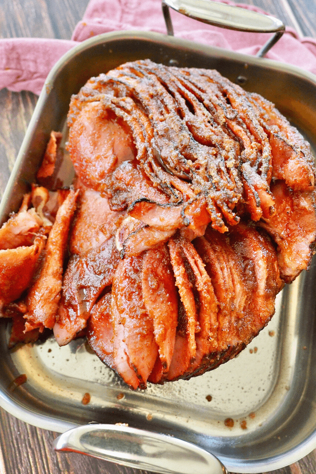 Top down shot of honeybaked spiral cut ham in roasting pan, perfectly juicy and sugar-crusted.