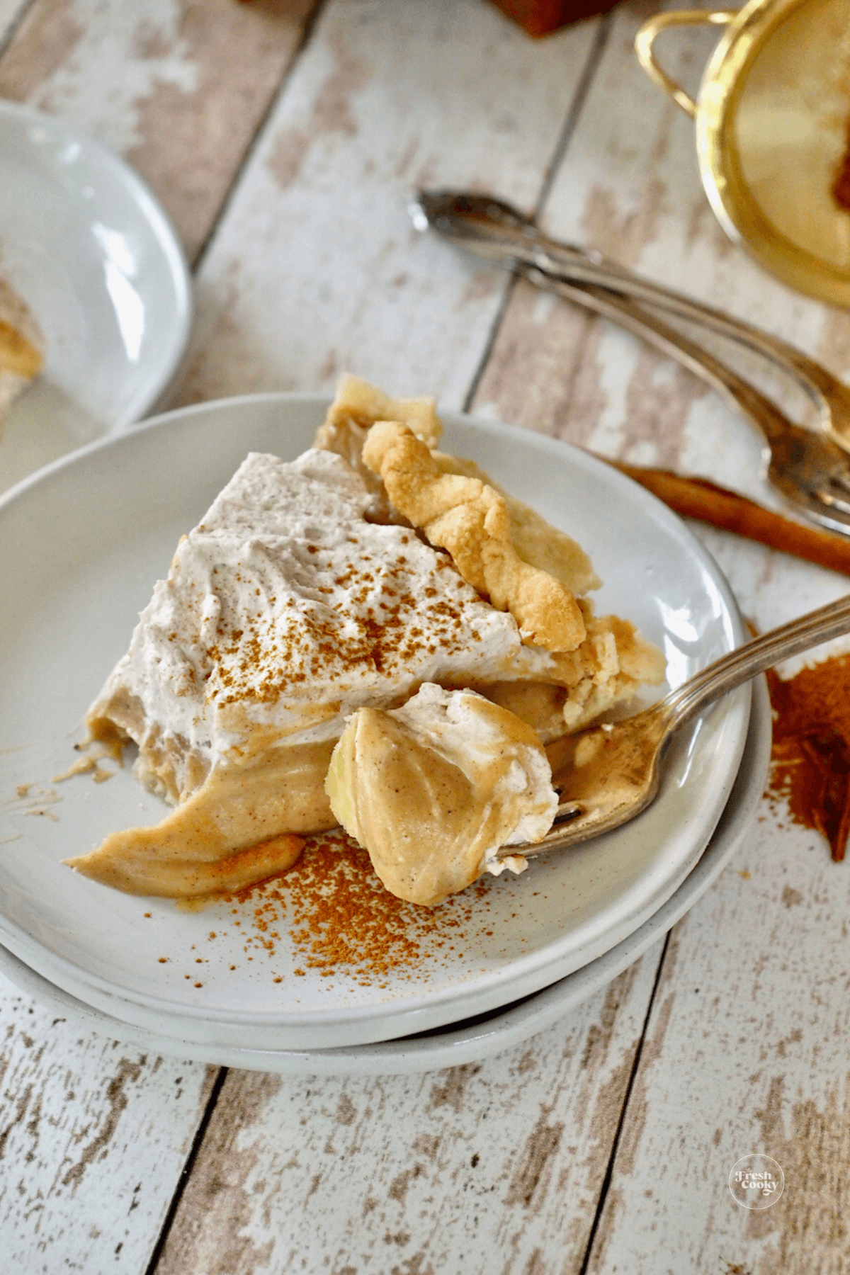 Slice of Butterscotch Cinnamon Pie with bite on a fork.