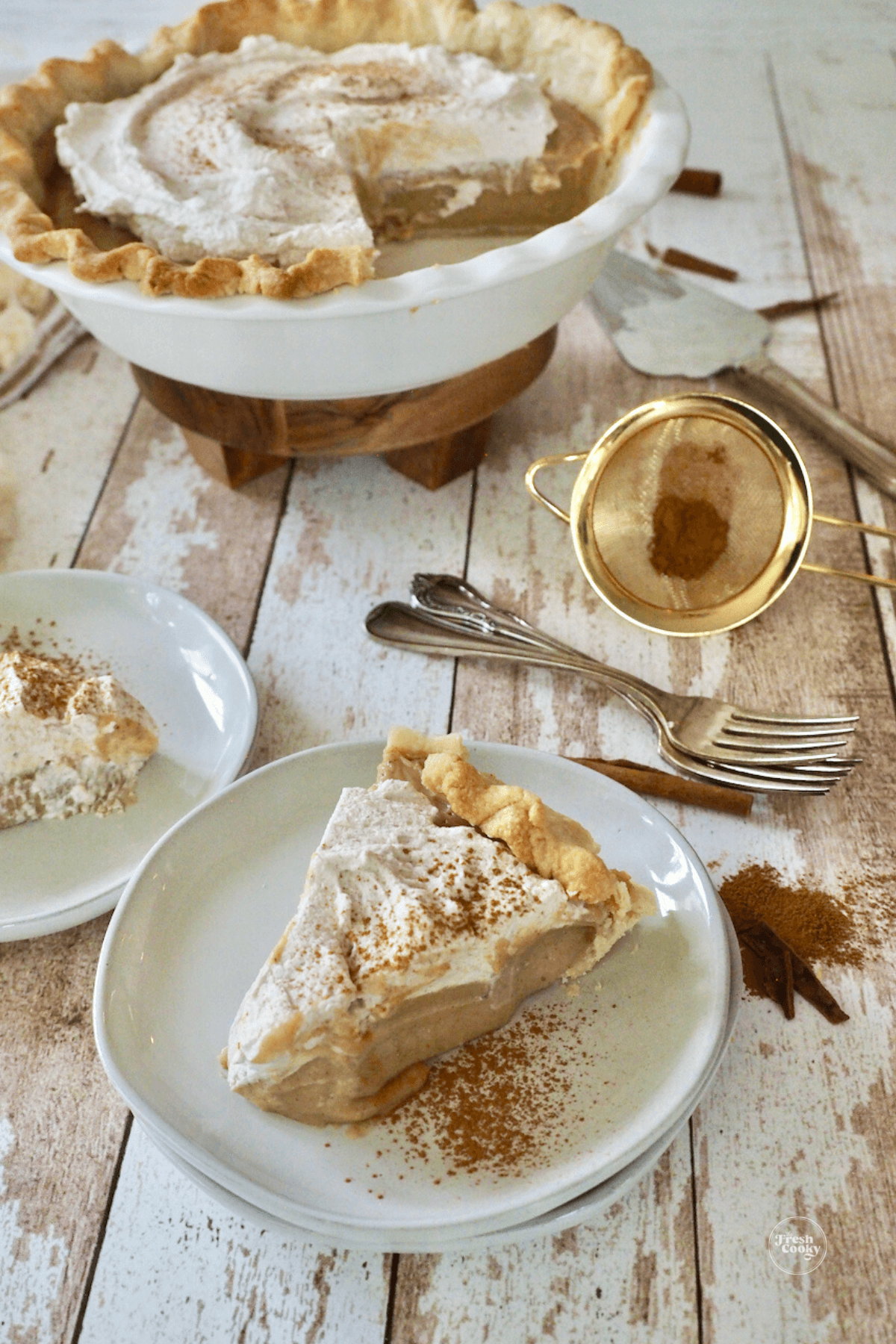 Sliced piece of butterscotch cinnamon pie, with whole pie in background.