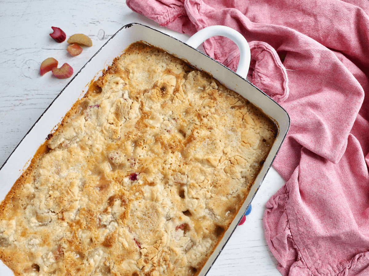 Rhubarb dump cake in pretty white baking dish.