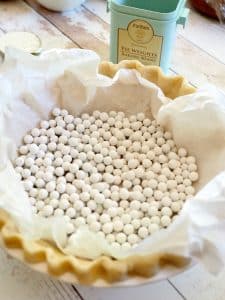 Pie weights in parchment lined unbaked pie shell.