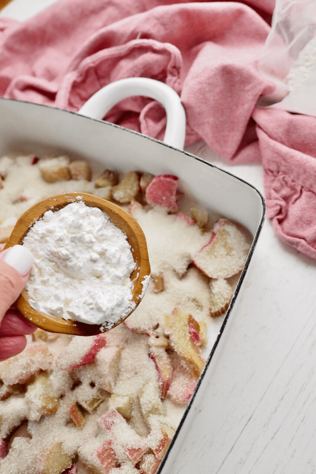 Sprinkling cornstarch over the rhubarb slices. 