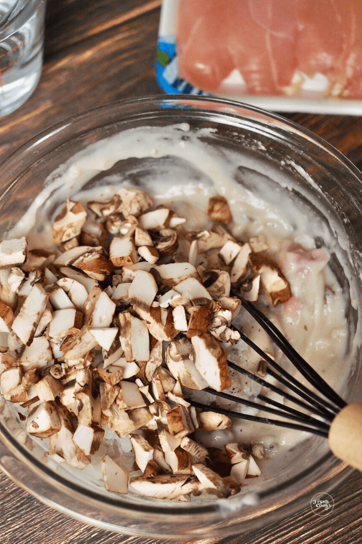 Adding fresh mushrooms to gravy mixture for Cracker Barrel Chicken and Rice recipe. 