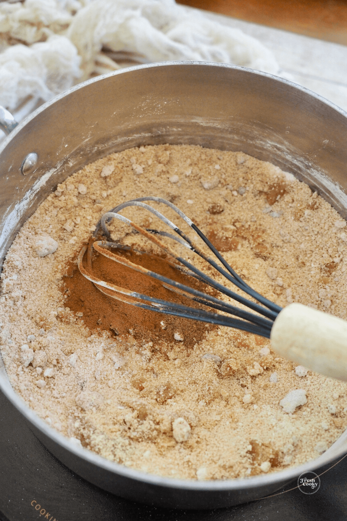 Stirring in cornstarch, brown sugar and spices to butterscotch cinnamon pie. 