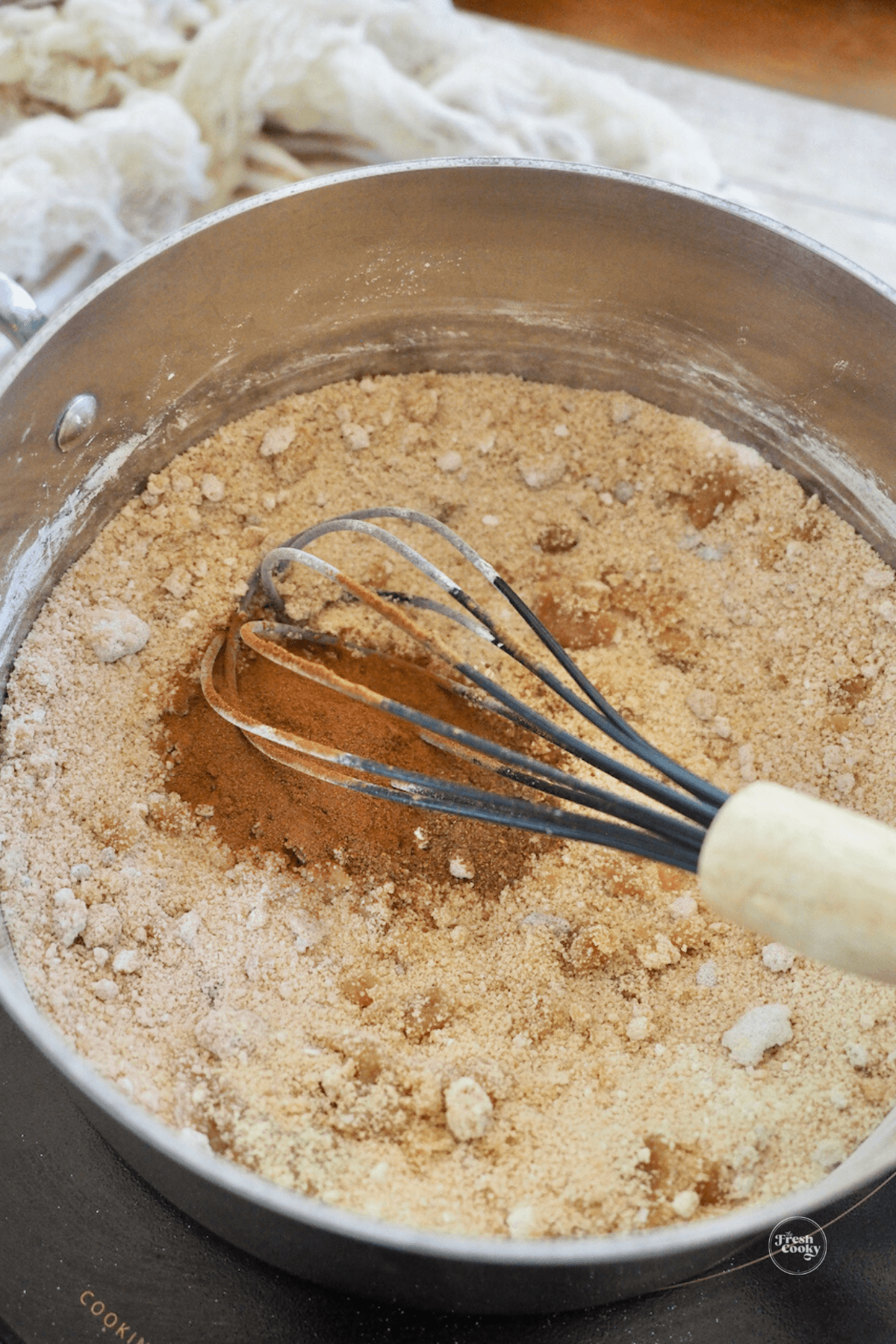 Stirring in cornstarch, brown sugar and spices to butterscotch cinnamon pie.