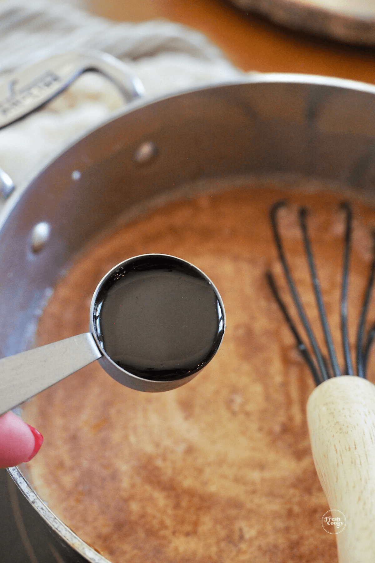 Adding vanilla bean paste into mixture.