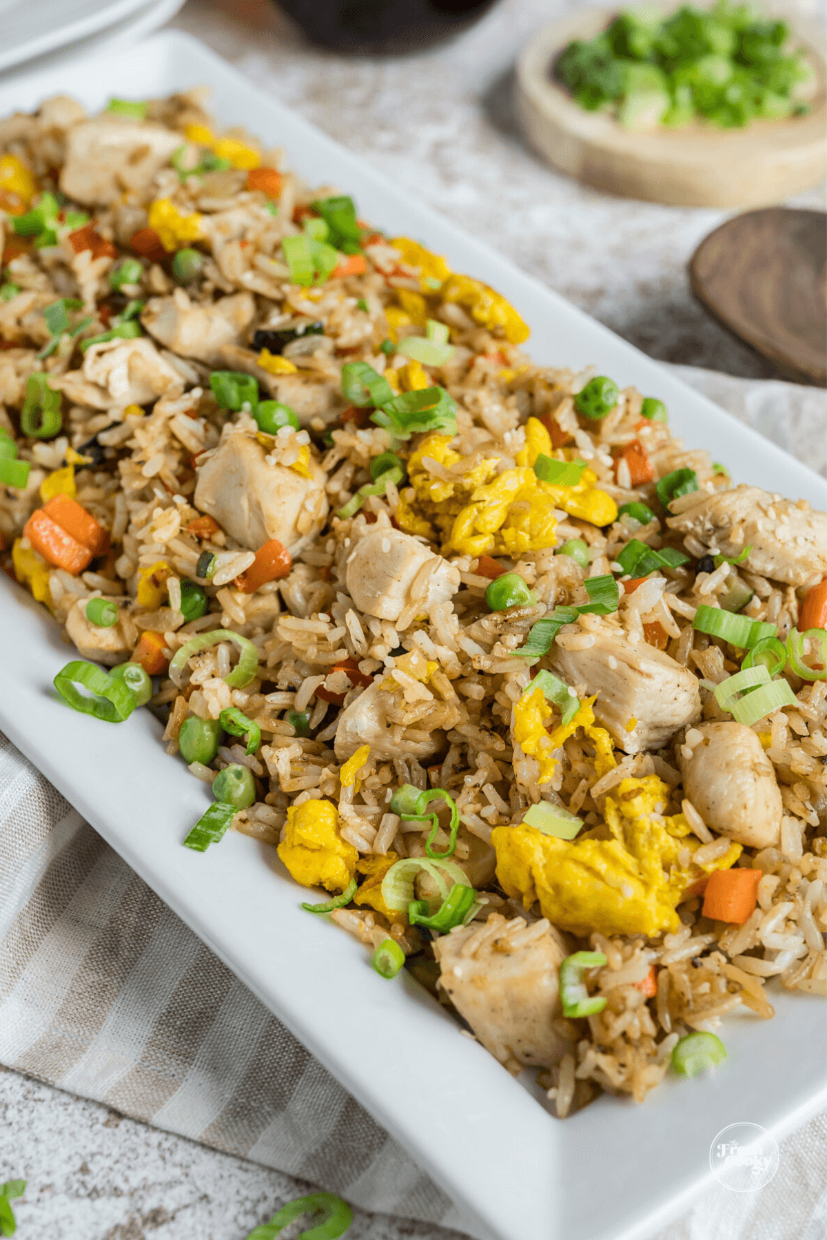 Large serving platter filled with chicken fried rice made on blackstone griddle.