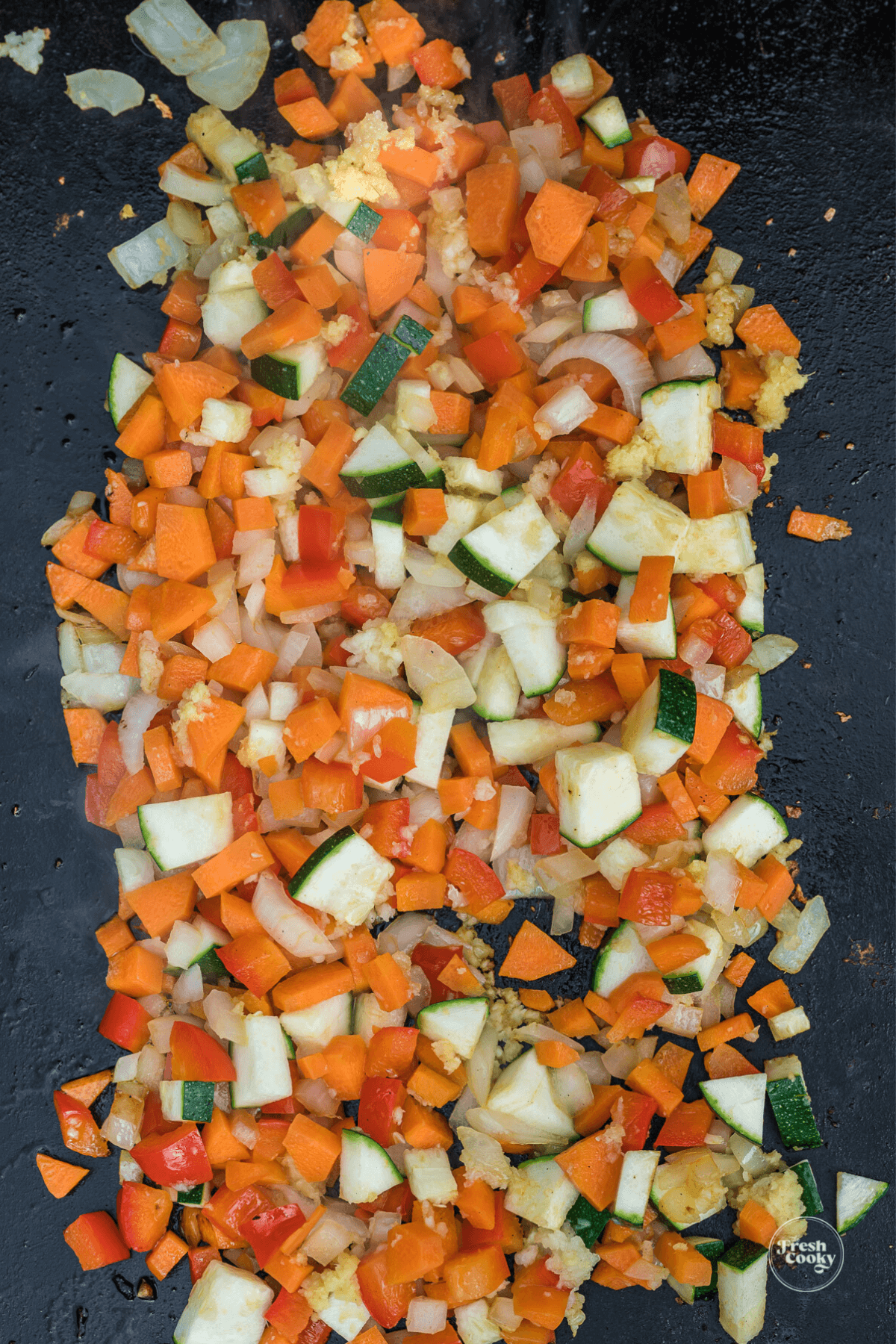 Sauteing veggies for chicken fried rice on blackstone griddle.