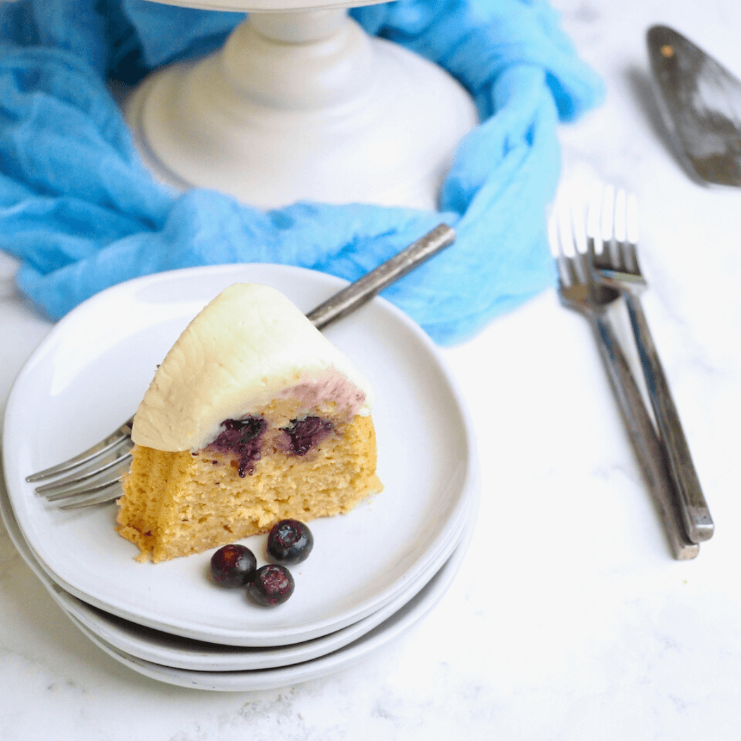 Blueberry Pancake Bundt Cake with slice of bundt recipe on plate with fork and blueberries.