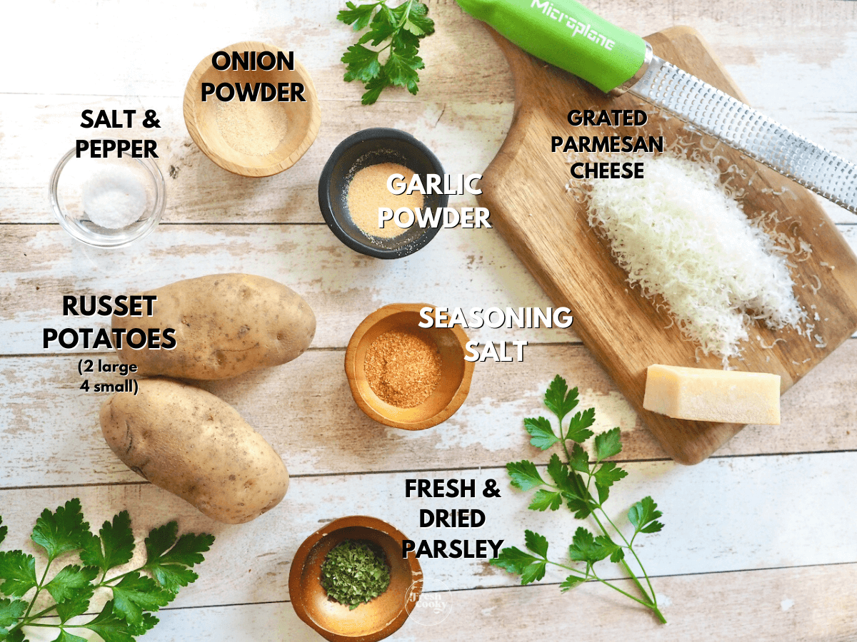 Labeled ingredients for steak fries L-R Russet Potatoes, salt and pepper, onion powder, garlic powder, parmesan cheese, seasoning salt and dried and fresh parsley.