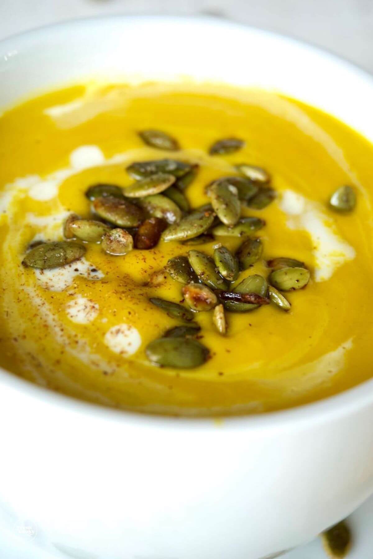 Close up of bowl of silky smooth and creamy Panera Autumn squash soup. 
