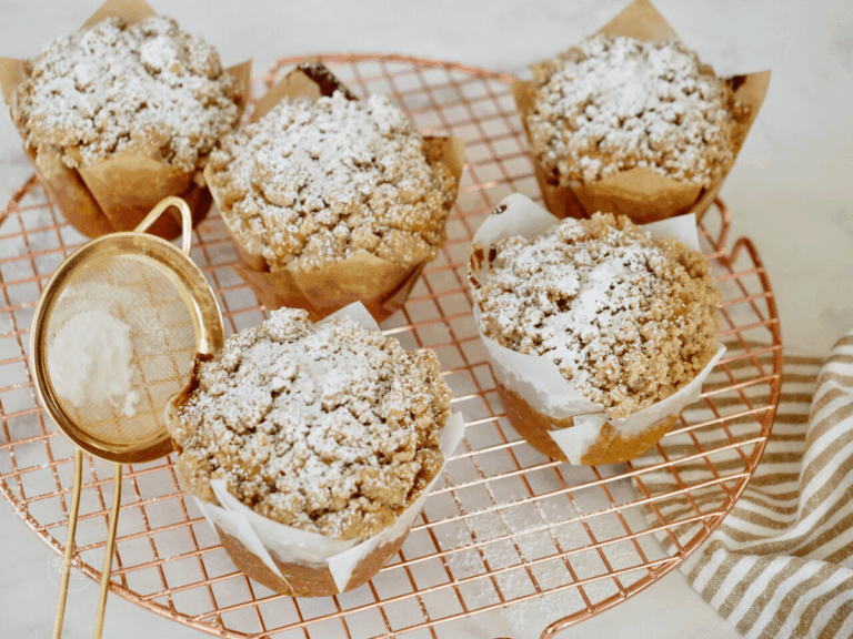 Panera pumpkin muffins recipe copycat on cooling rack, dusted with powdered sugar.