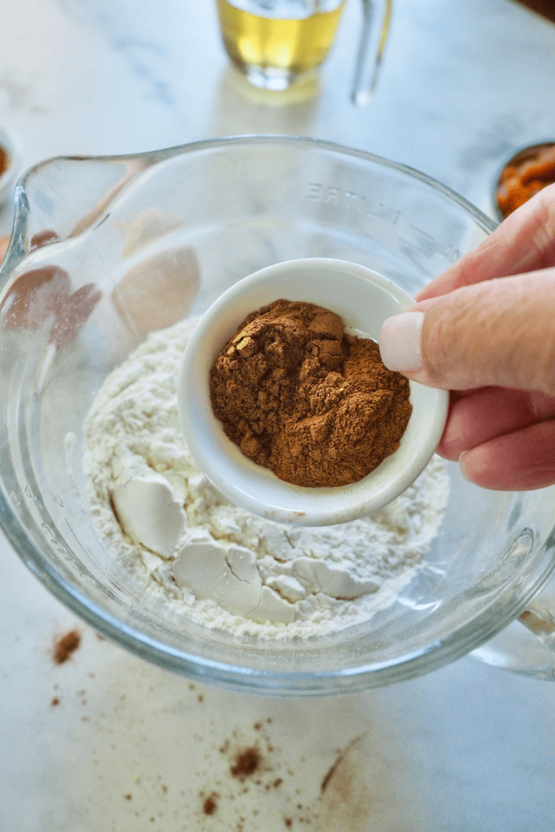 Adding cinnamon and pumpkin pie spices to dry ingredients. 