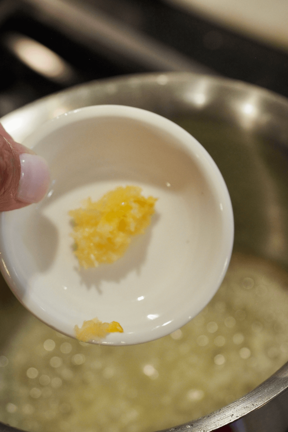 Adding garlic to browned butter. 