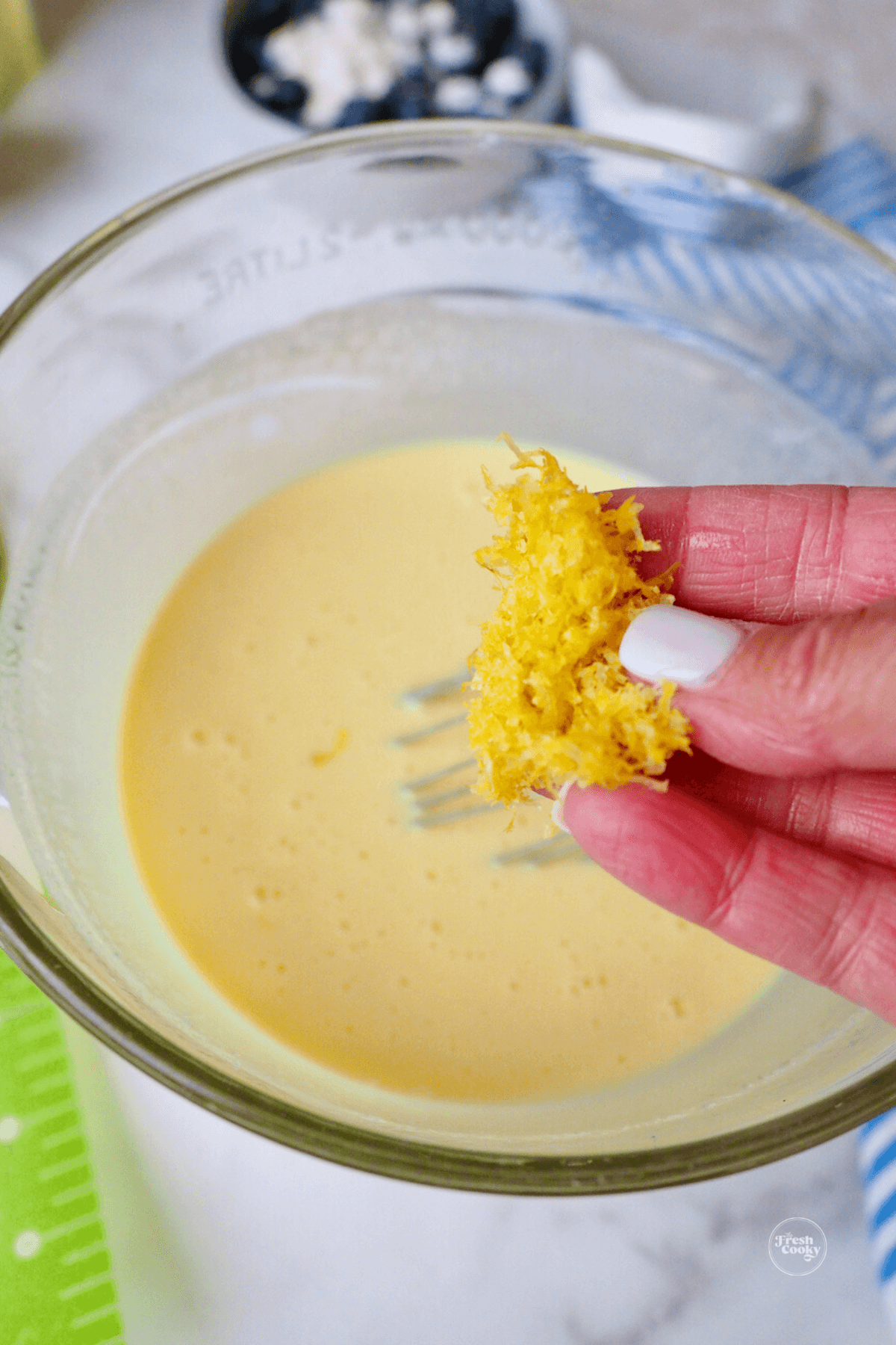 Adding lemon zest to batter mixture. 