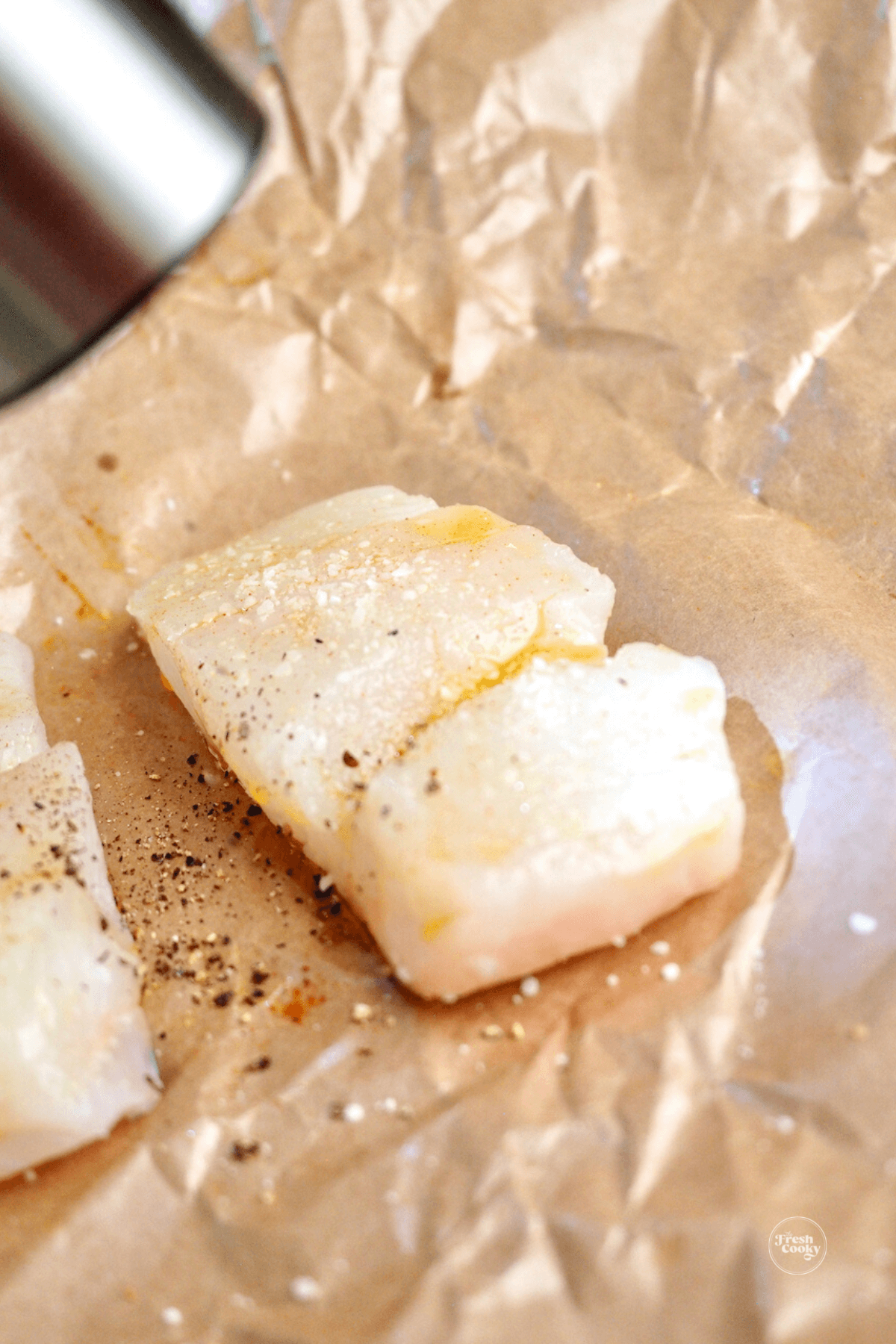 Adding salt, pepper and paprika to filet. 