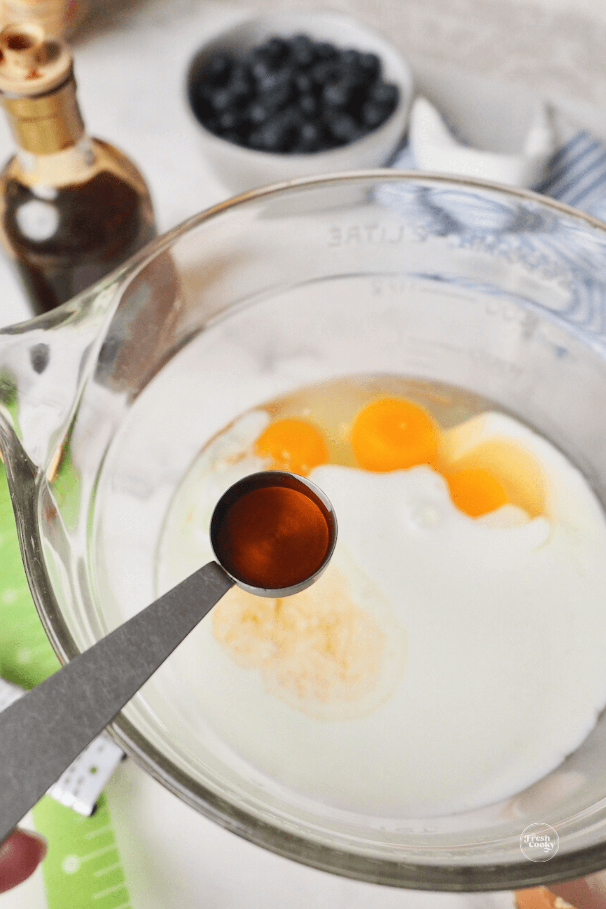 Adding vanilla extract to wet ingredients.