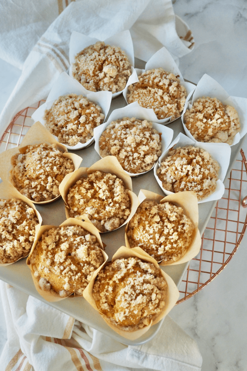 Baked Panera Pumpkin Muffins in ton on cooling rack.