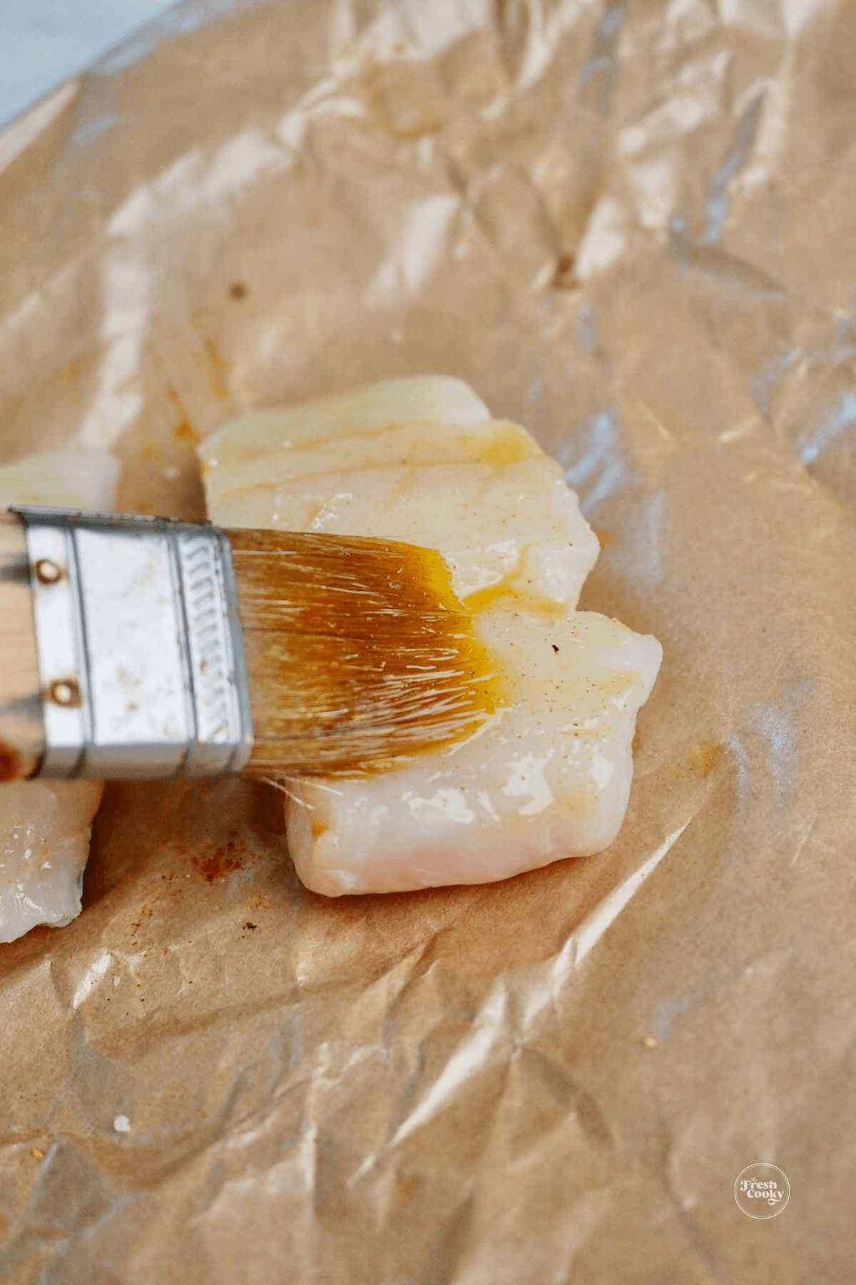 Brushing on olive oil to filet.