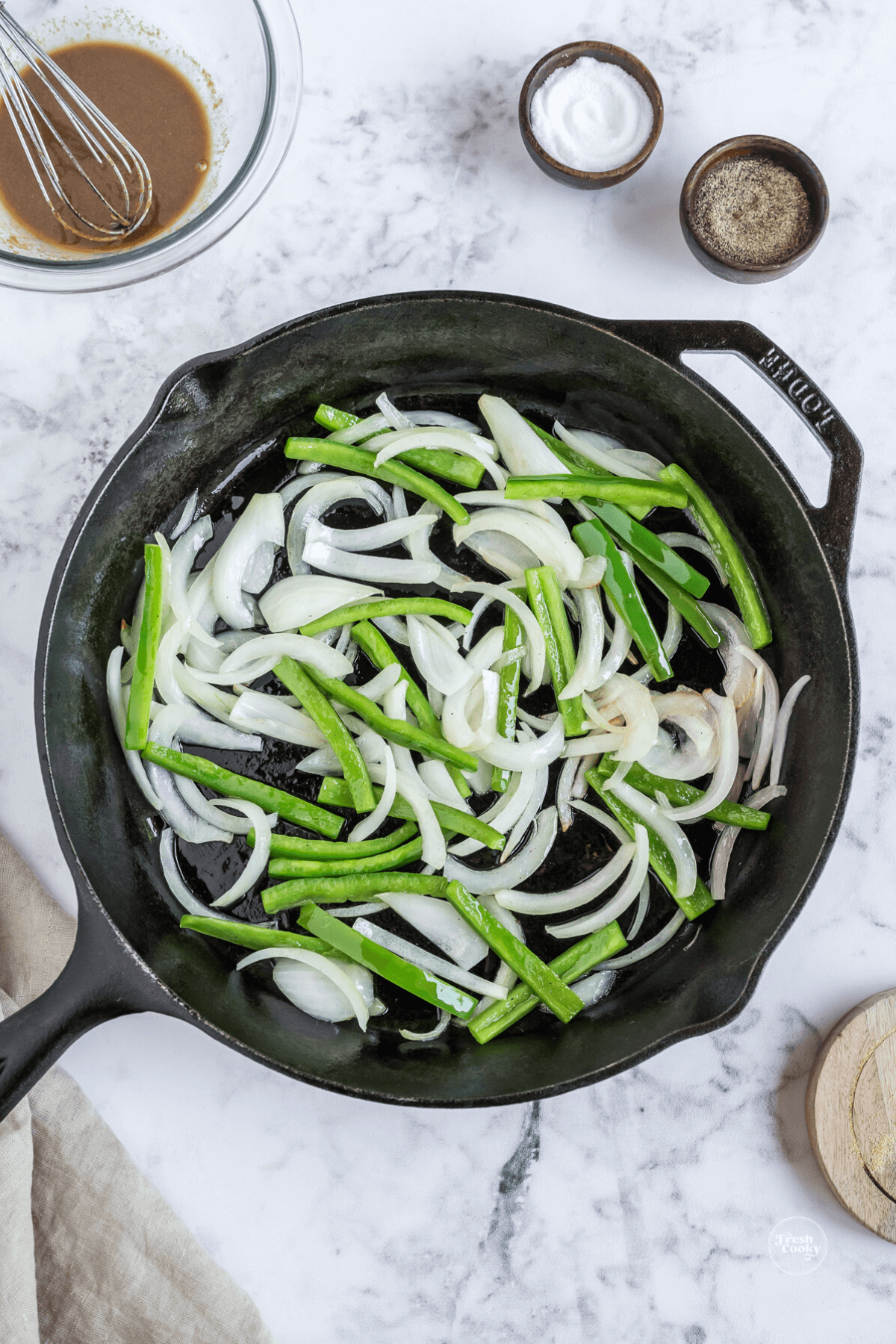 Caramelize onions and green peppers in skillet.