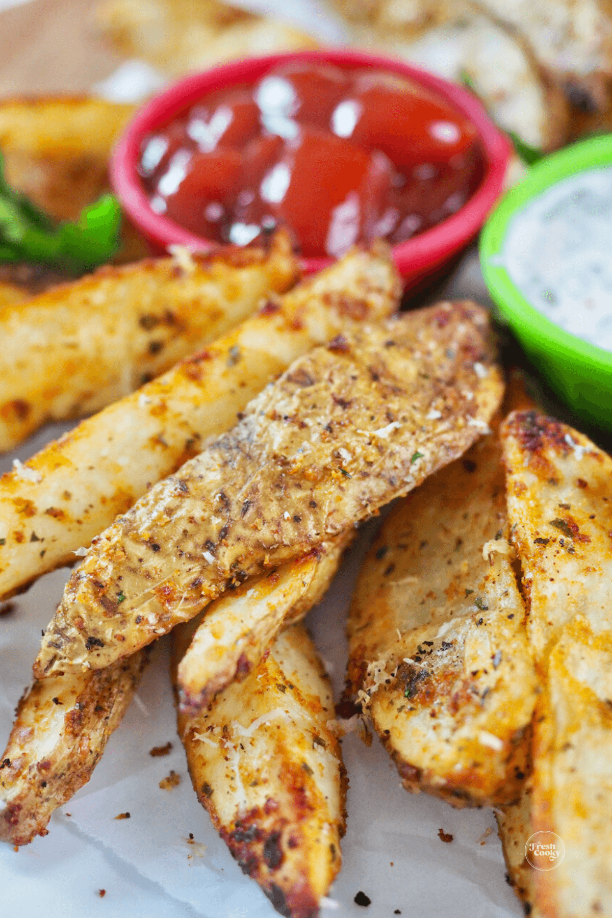 Crispy steak fries with ketchup in background.