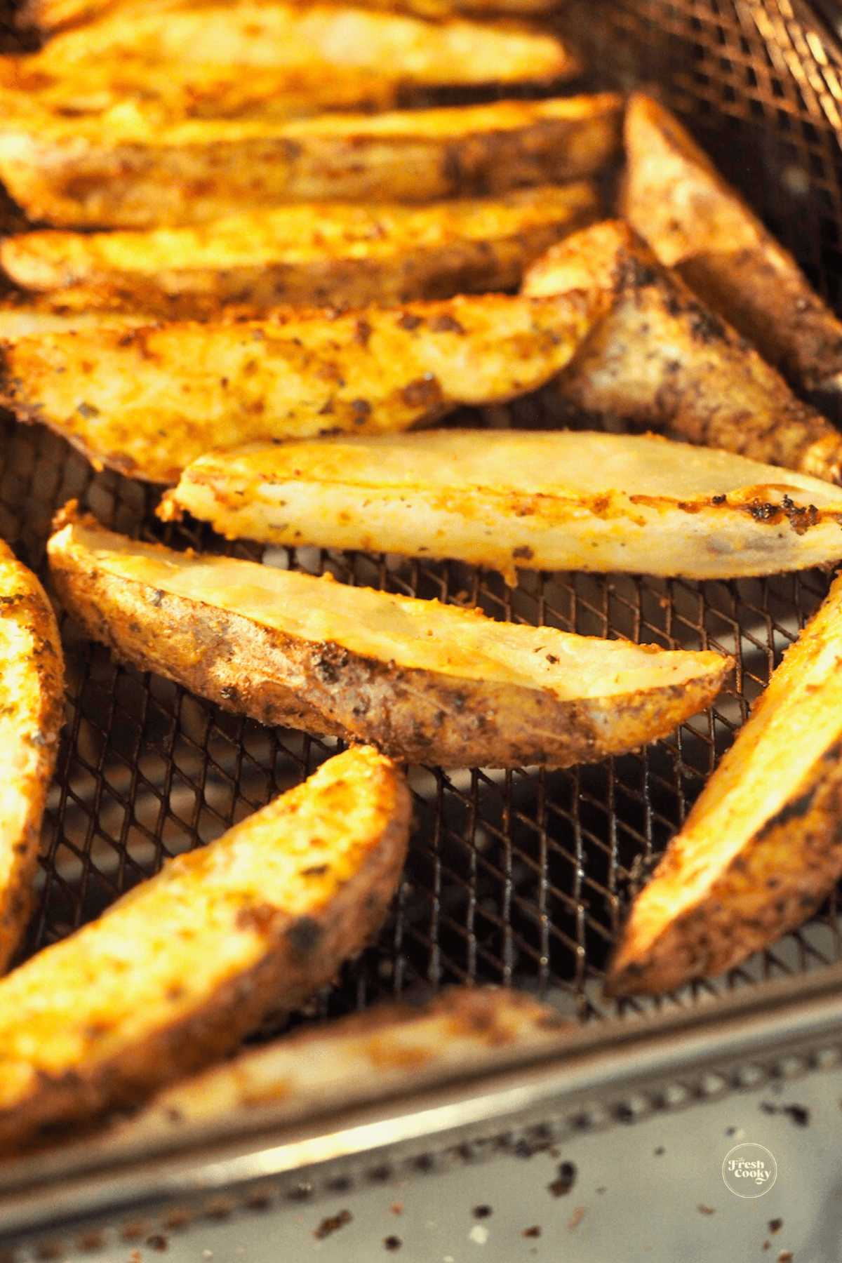 Steak fries crisping up in air fryer basket. 