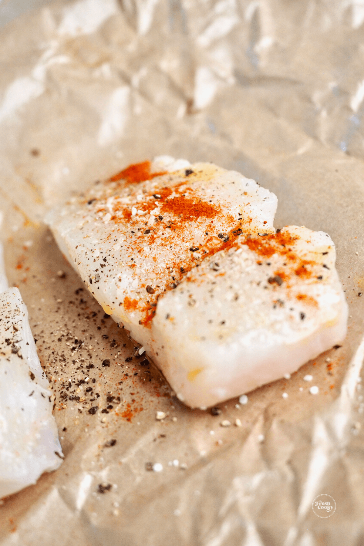Fish filet sprinkled with salt, pepper and paprika. 