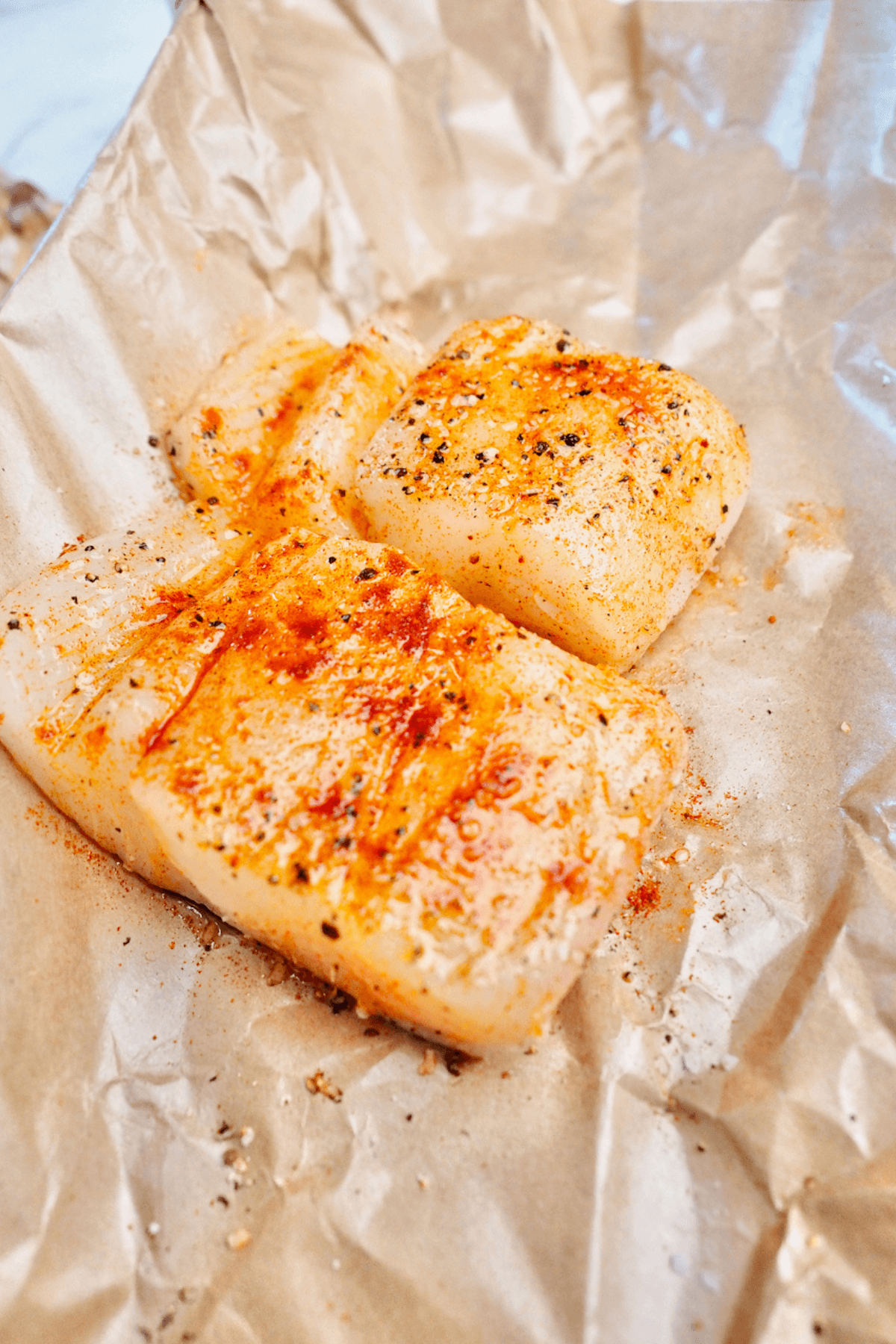 Halibut filets seasoned and ready for air fryer.