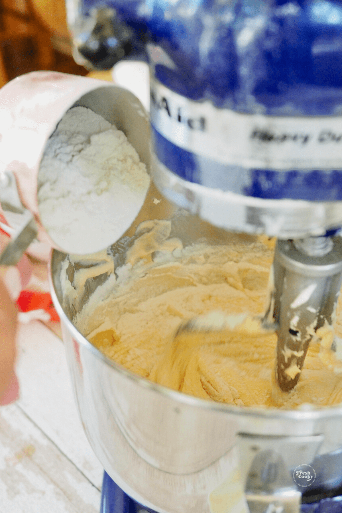 Adding flour mixture to cake batter. 