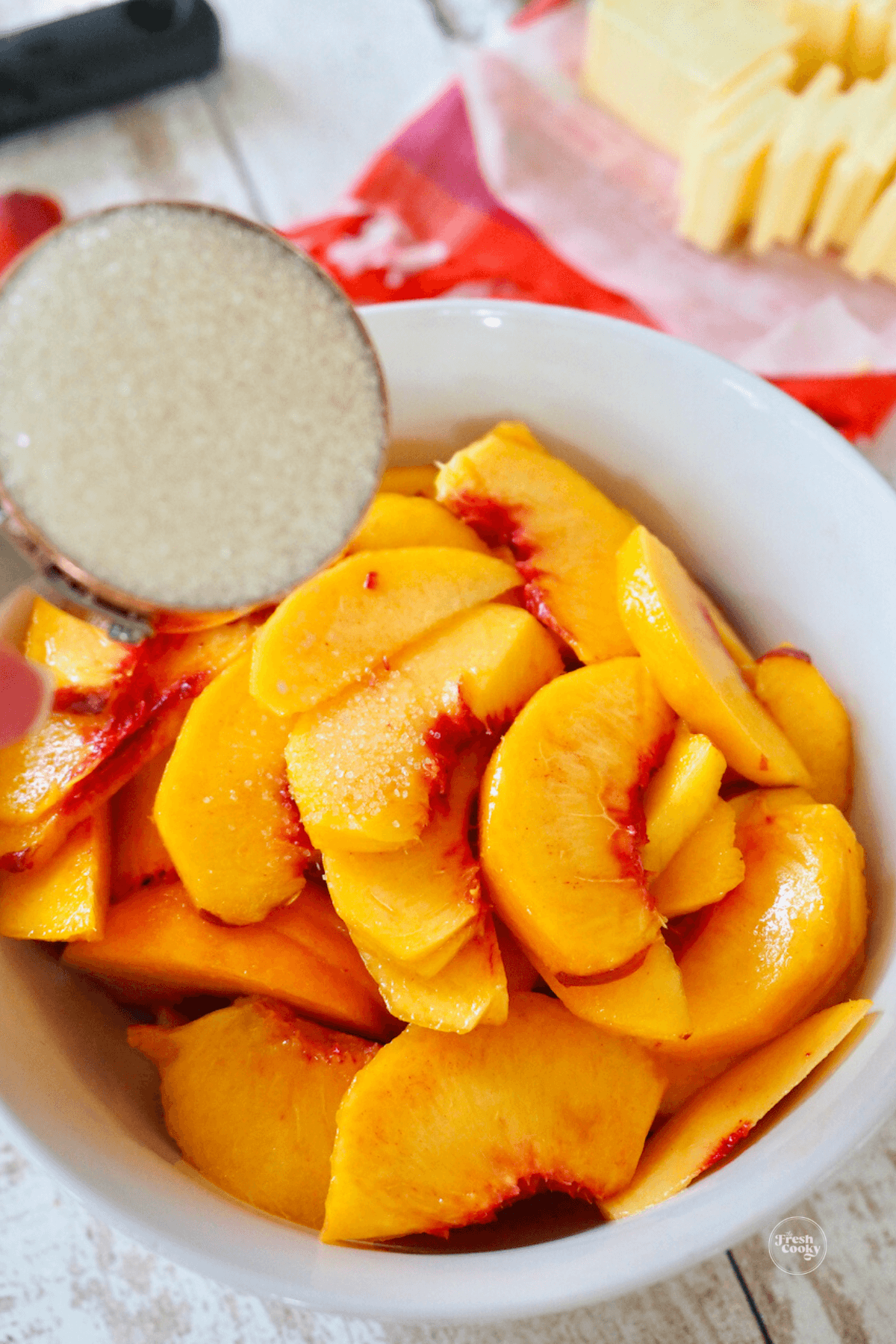 Adding sugar to peaches. 