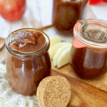Apple butter made in the instant pot spooned into a cute jar with apple slices.