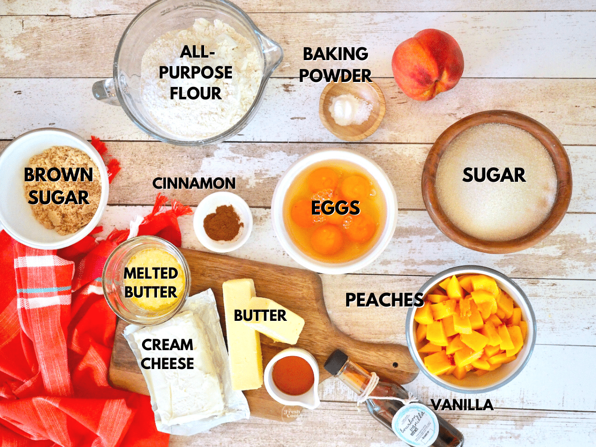 Labeled ingredients for peach pound cake recipe L-R Brown sugar, flour, baking powder, sugar, peaches, eggs, bourbon vanilla, butter, cinnamon, melted butter and cream cheese.