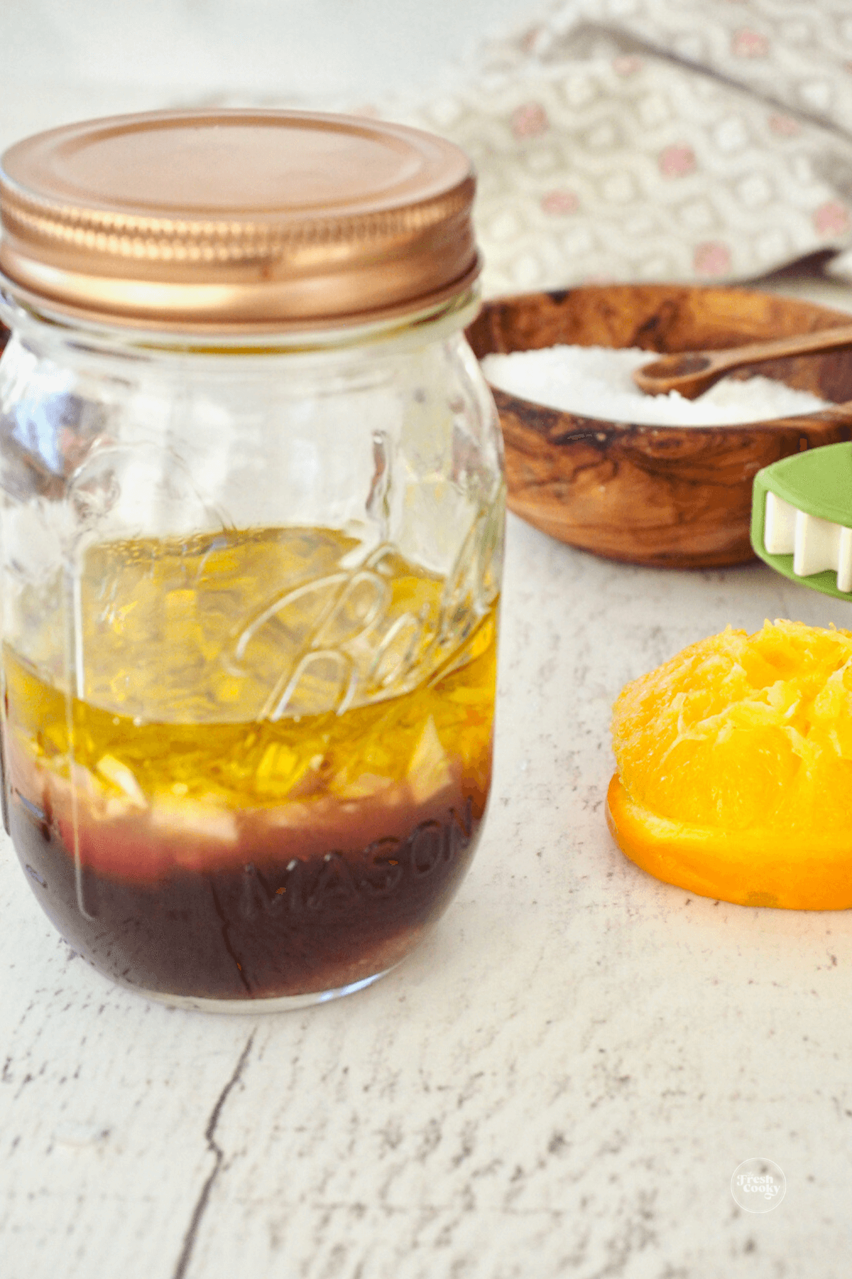 Separated salad dressing ingredients in mason jar. 