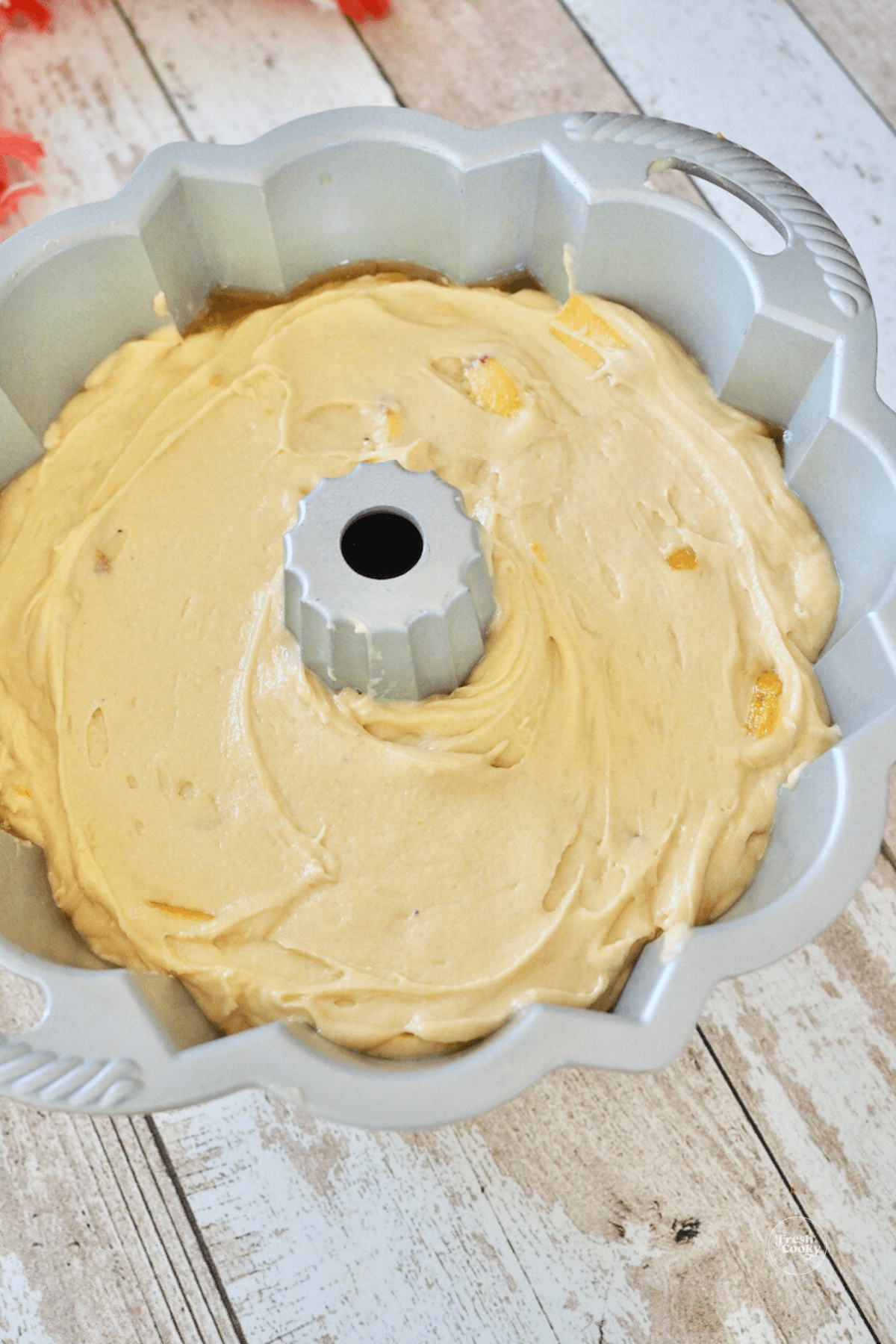 Smoothed cake batter in bundt pan. 