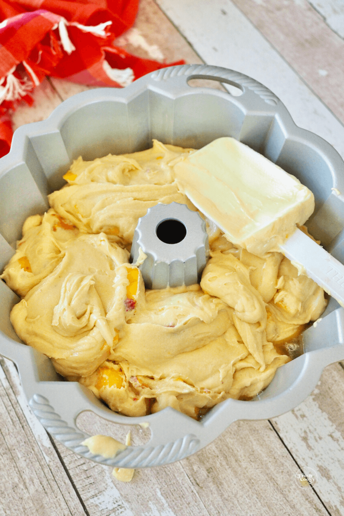 Smoothing batter in bundt pan. 