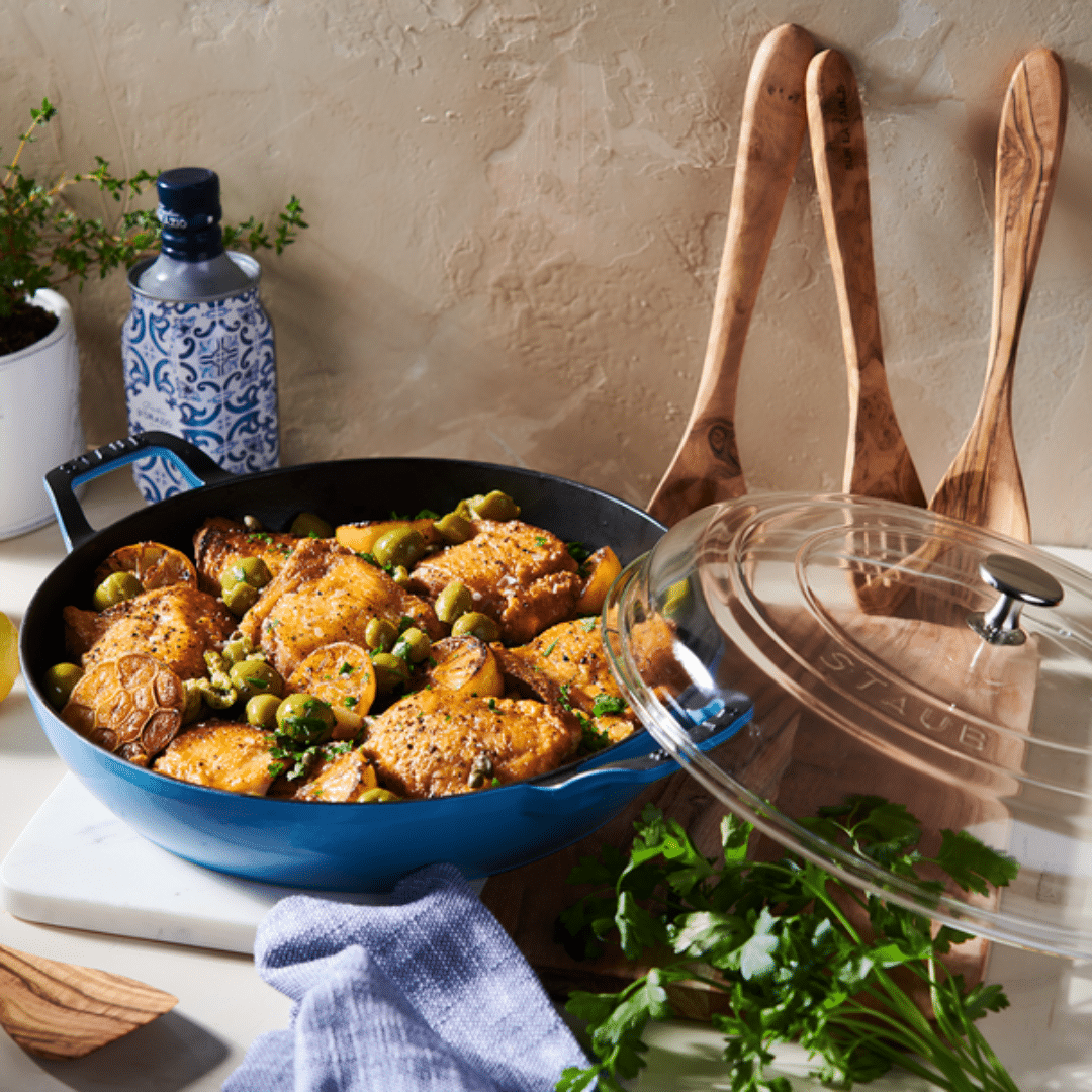 Staub Everyday Pan with glass lid and chicken inside.