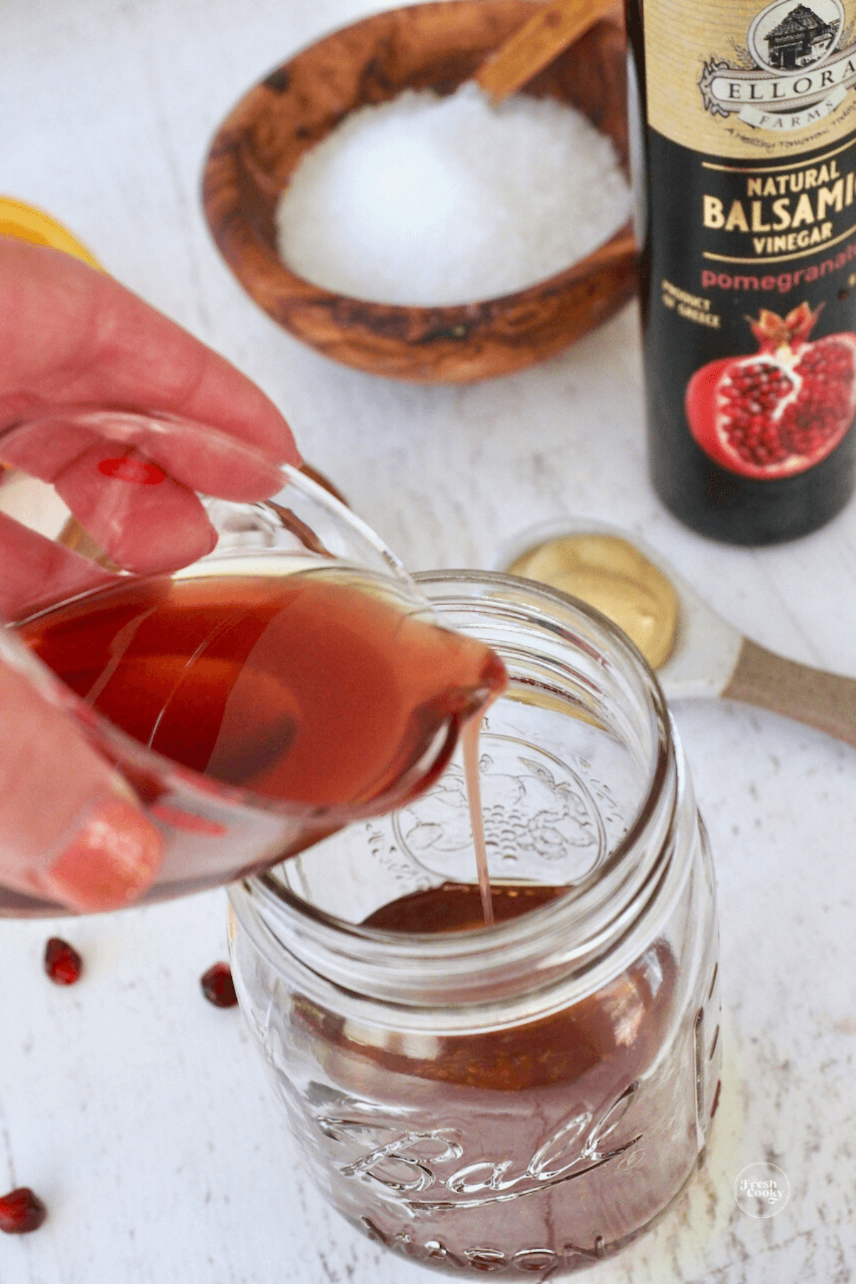 Adding balsamic vinegar to mason jar. 