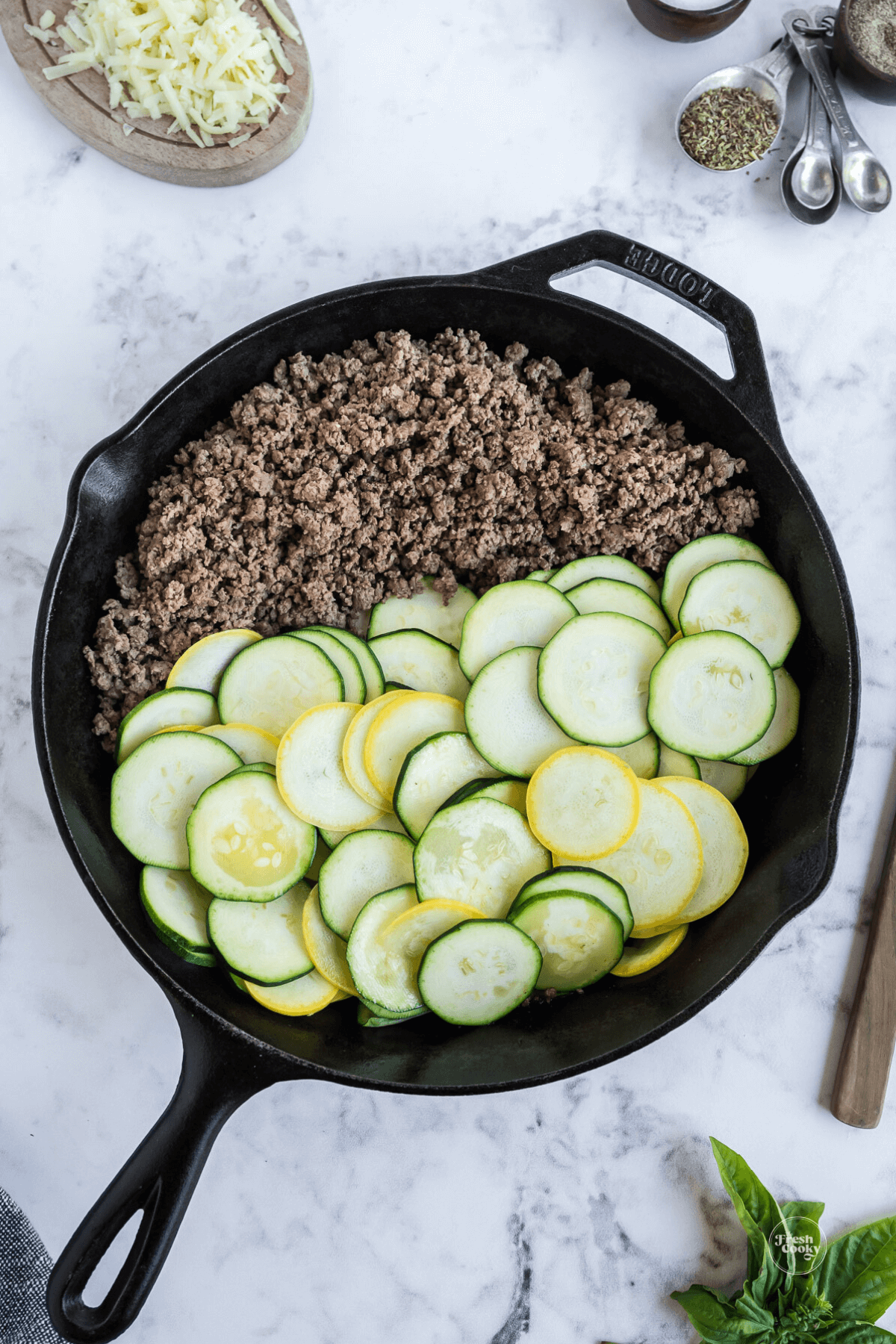 Sauteing zucchini with ground beef.