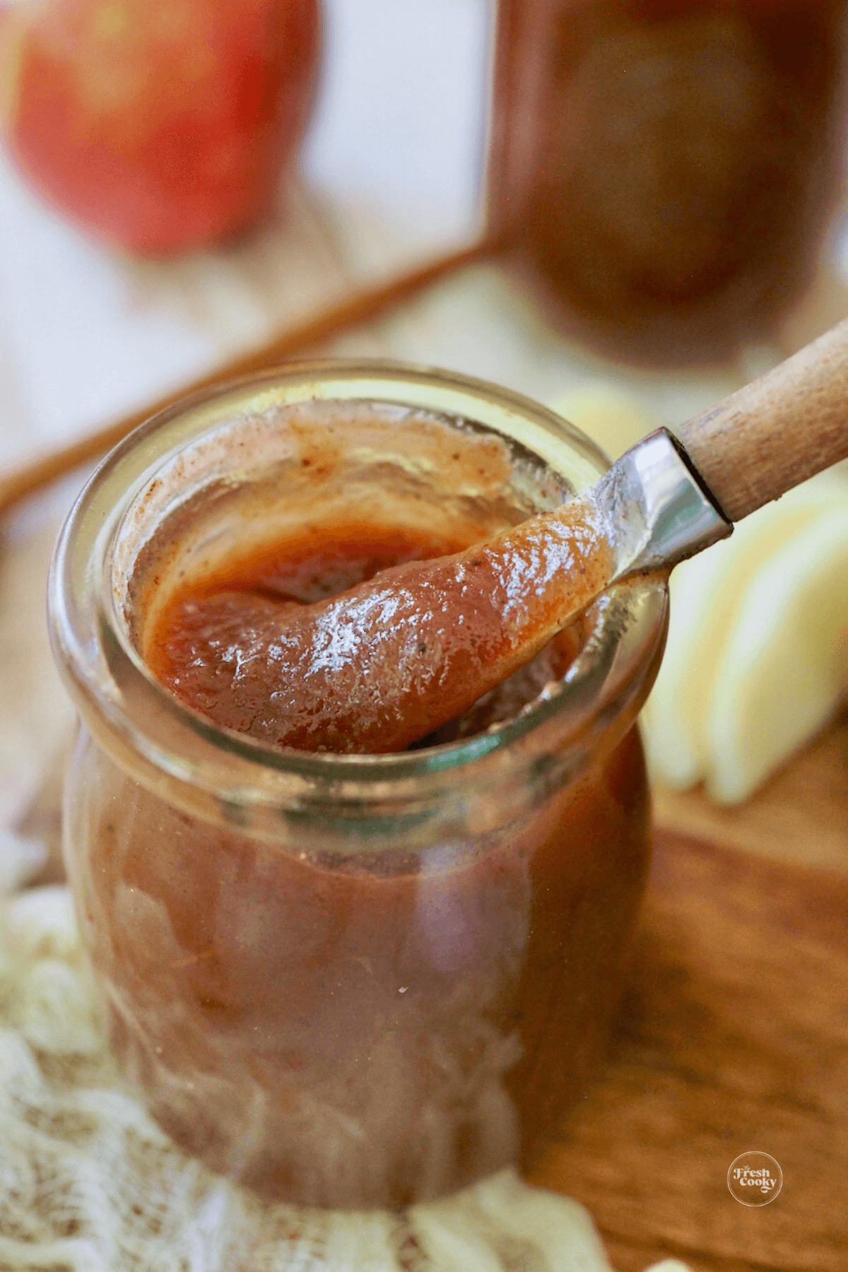 Apple Butter in jar with serving knife.