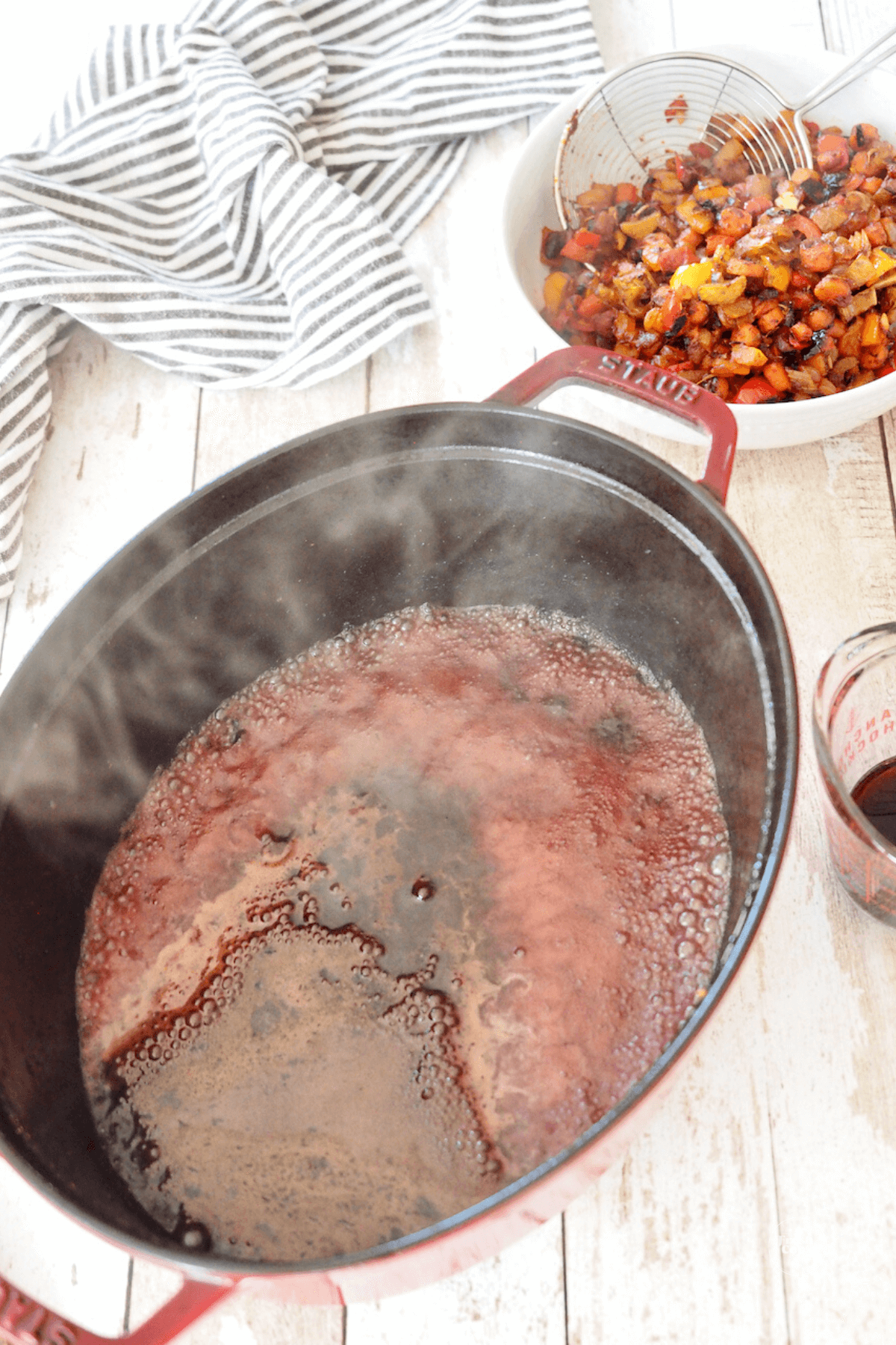 Deglazing pan with red wine.