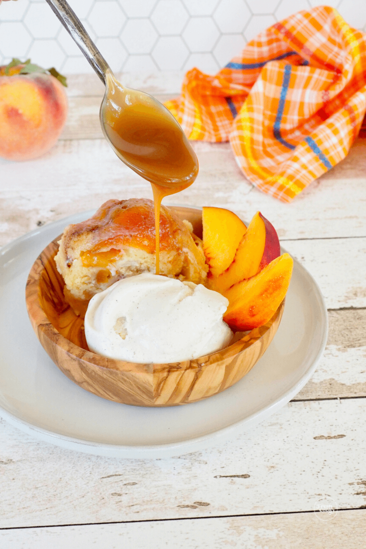Drizzling caramel on peach pound cake with ice cream.