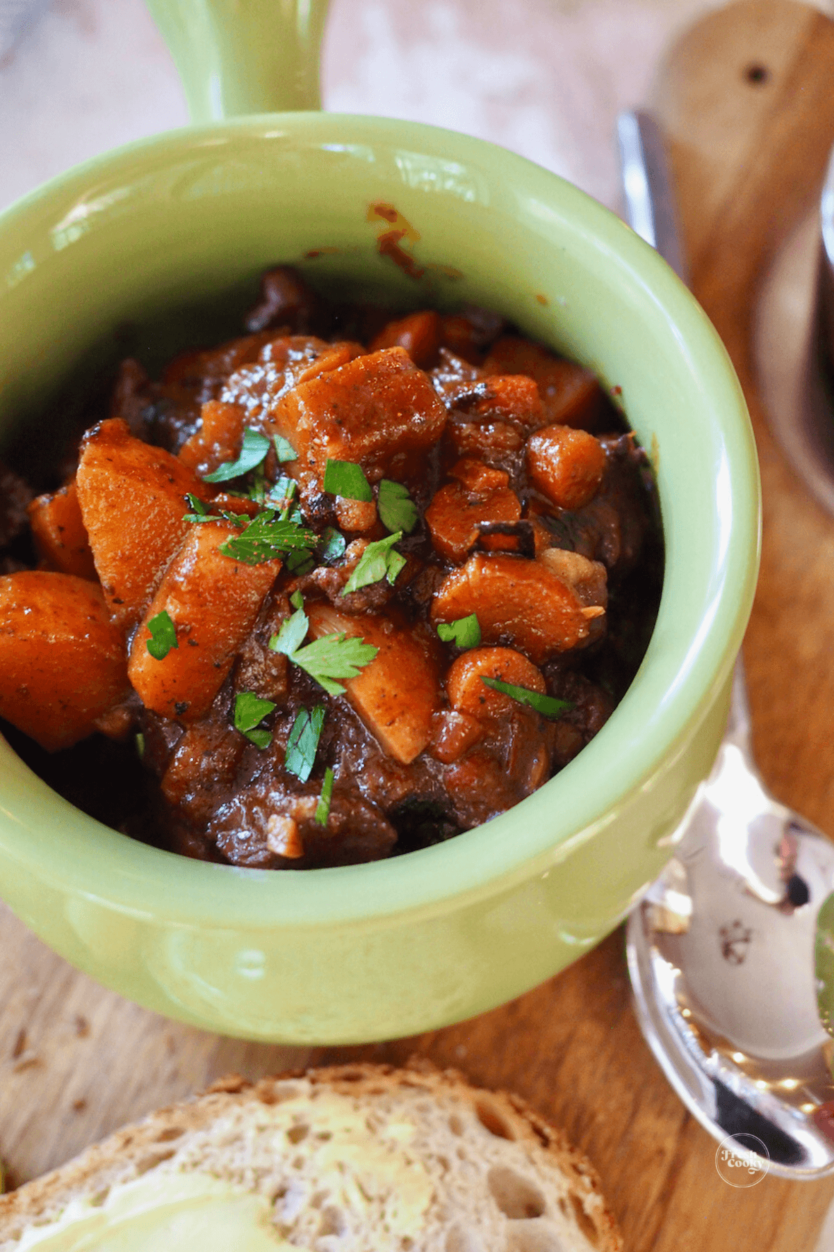 Bowl of German goulash soup rich with vegetables with rye bread.