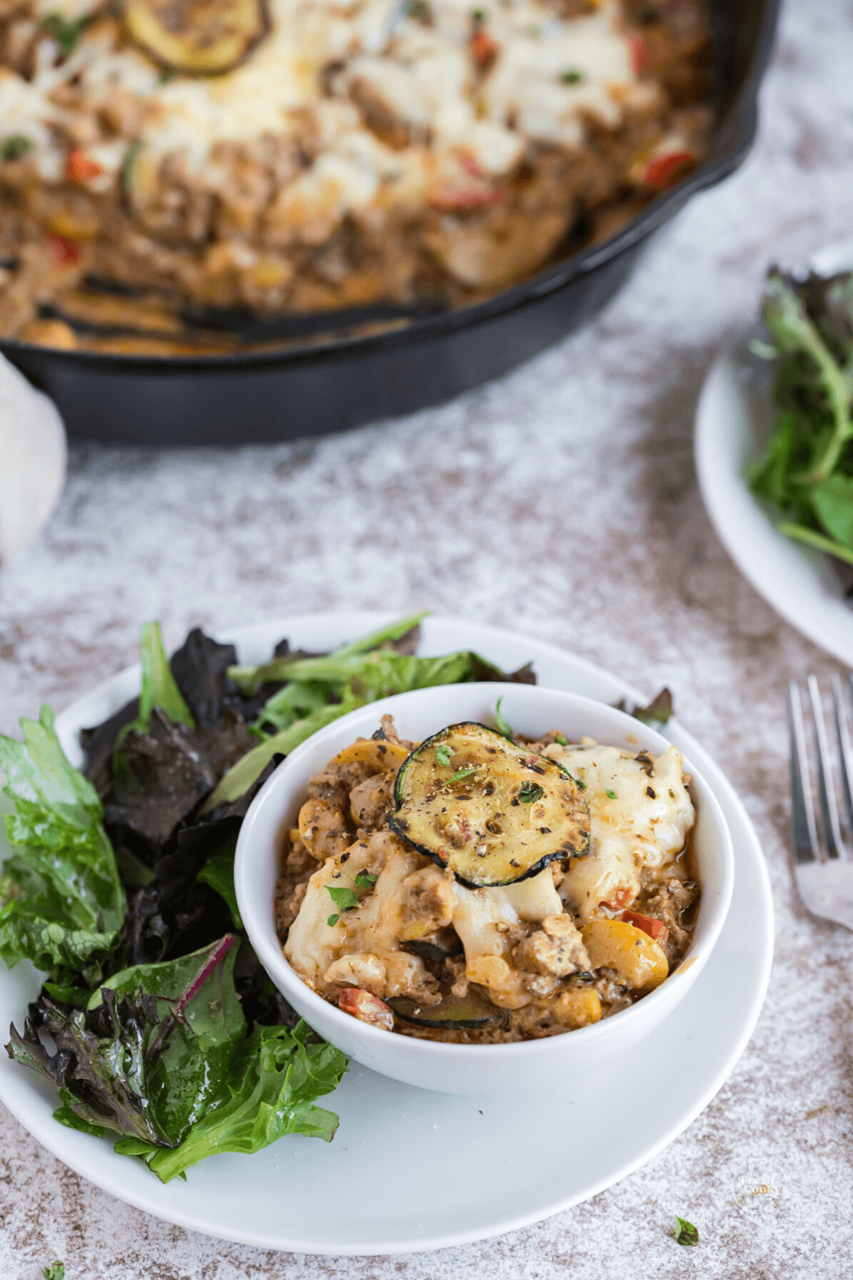 Serving of ground beef zucchini casserole on plate.