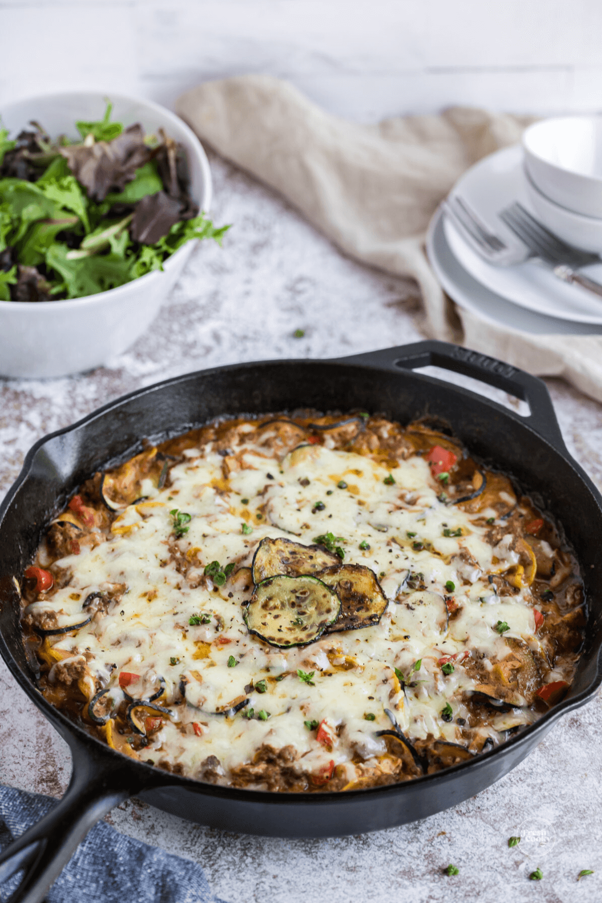 Skillet filled with ground beef and zucchini casserole.