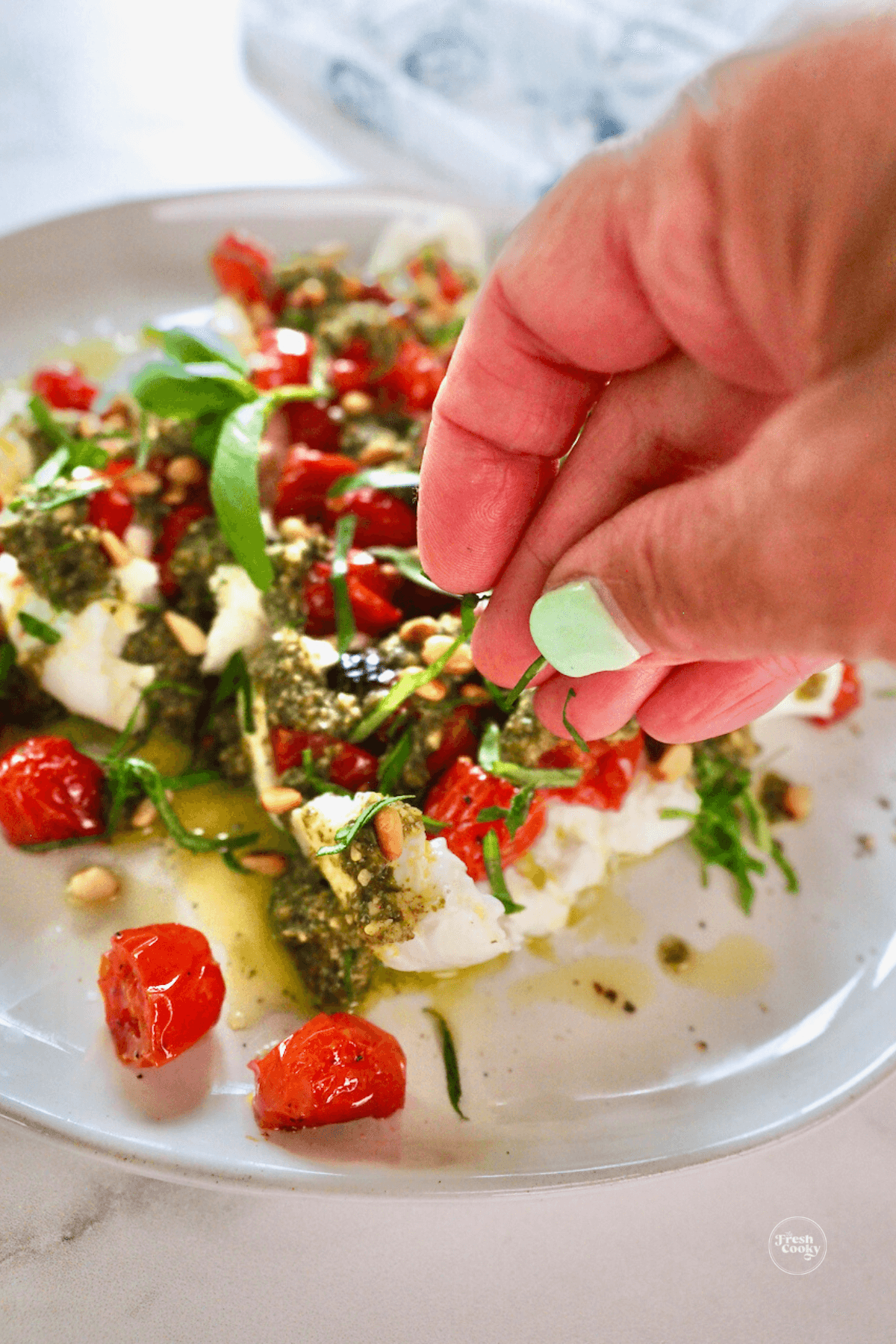 Sprinkling on some fresh basil. 