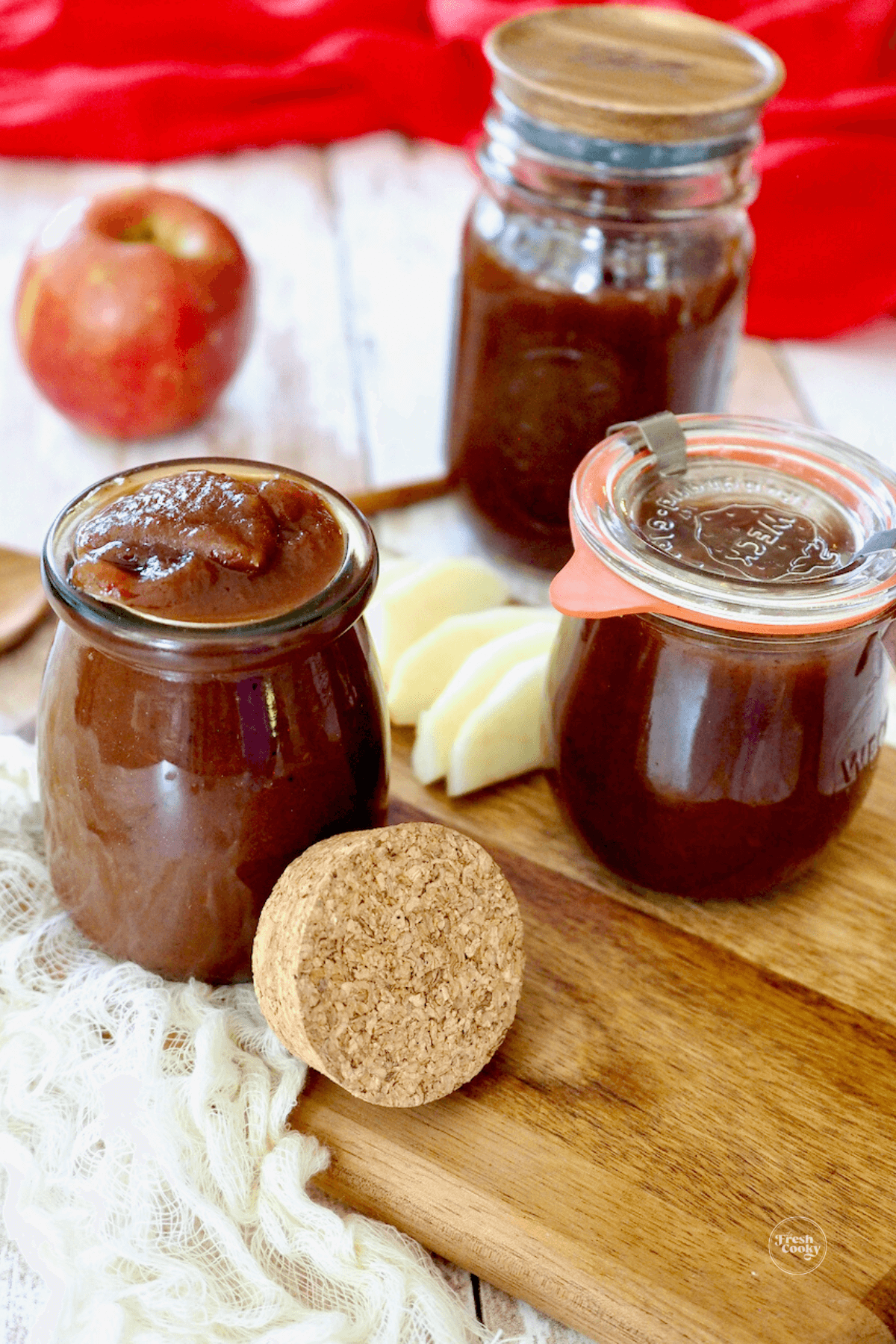 Apple butter spooned into jars.