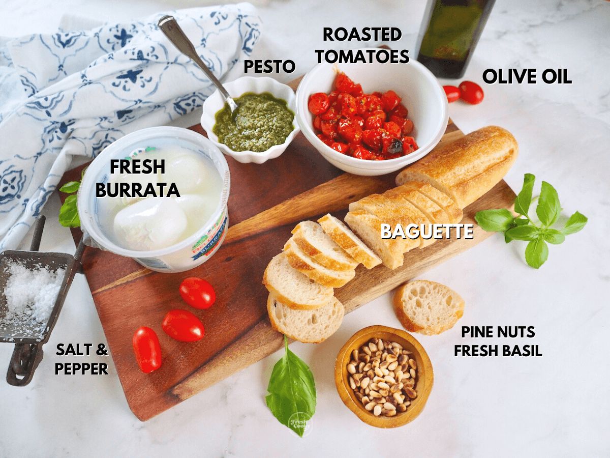 Labeled ingredients for pesto appetizer L-R Burrata pesto, roasted tomatoes, olive oil, baguette, basil salt and pepper, pie nuts.